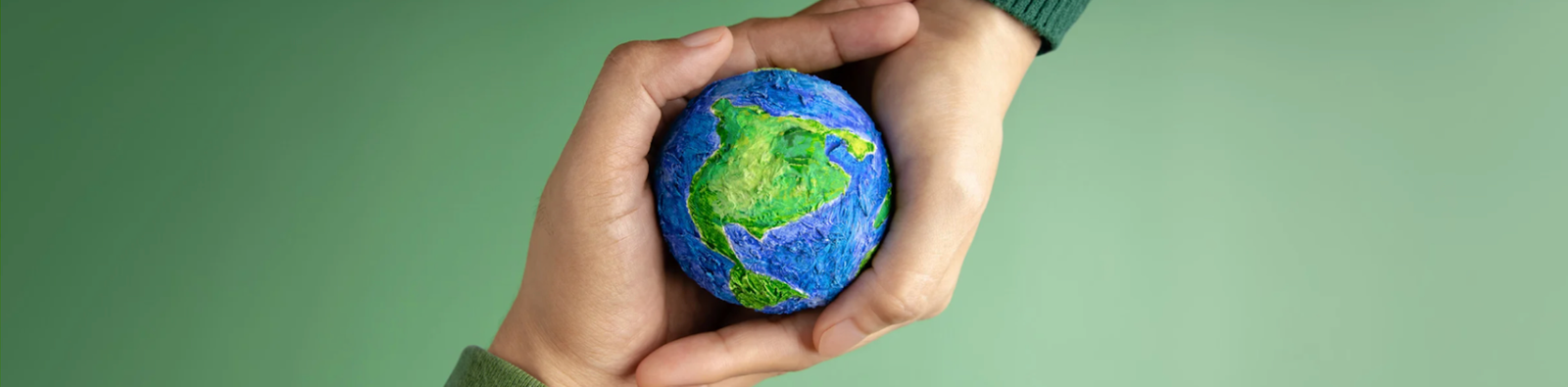 Hands holding the Earth globe, representing a commitment to sustainable roofing and environmental responsibility.